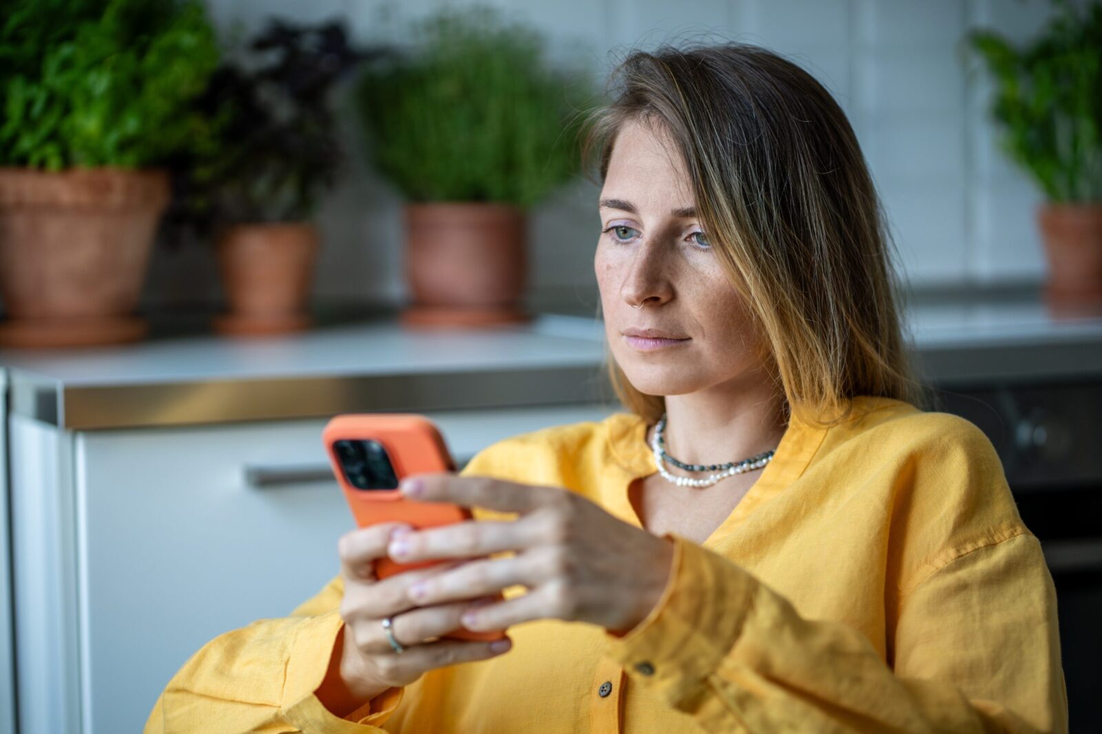 person looking at phone with serious face