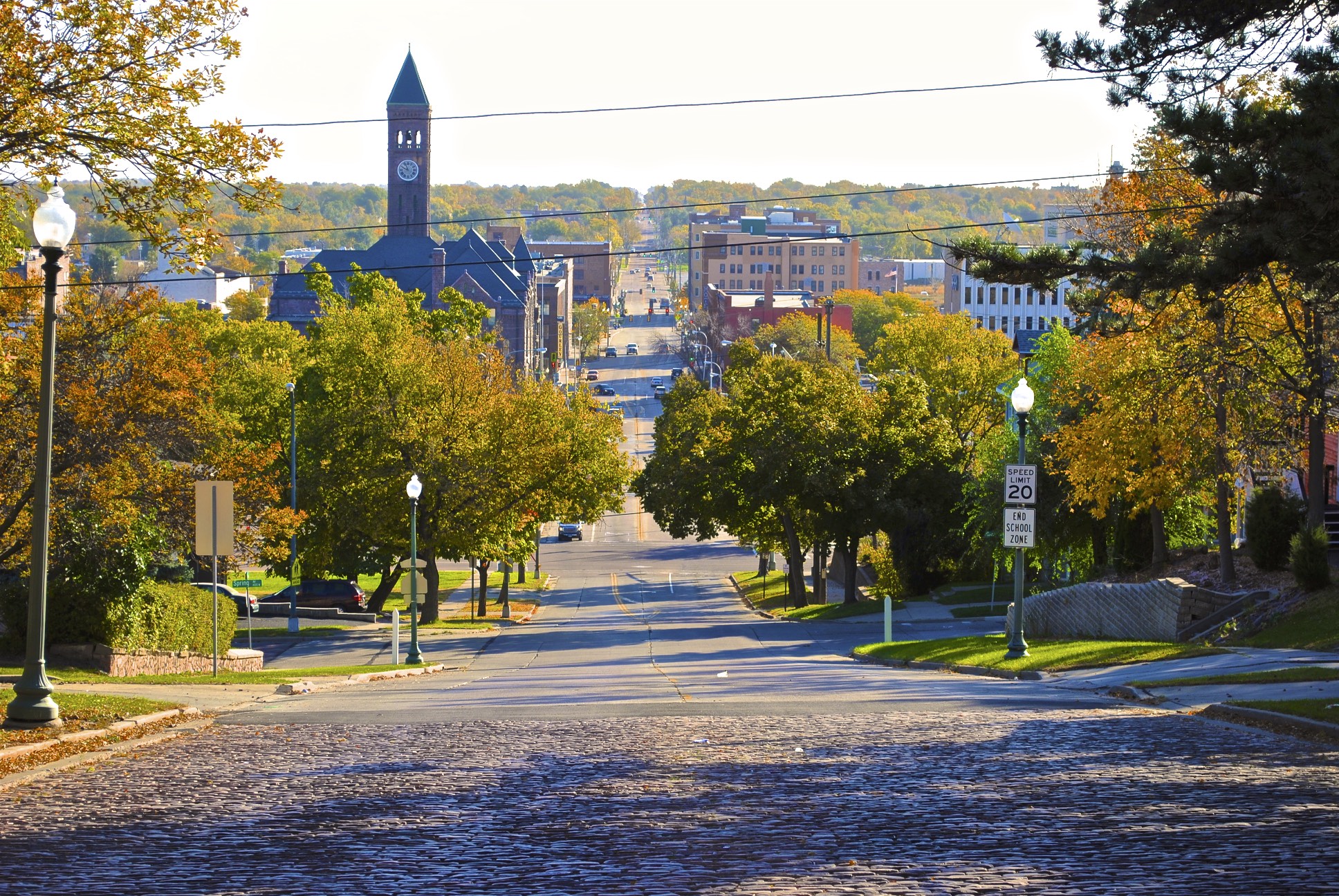 Photo of the main street through a small suburban town in the fall.