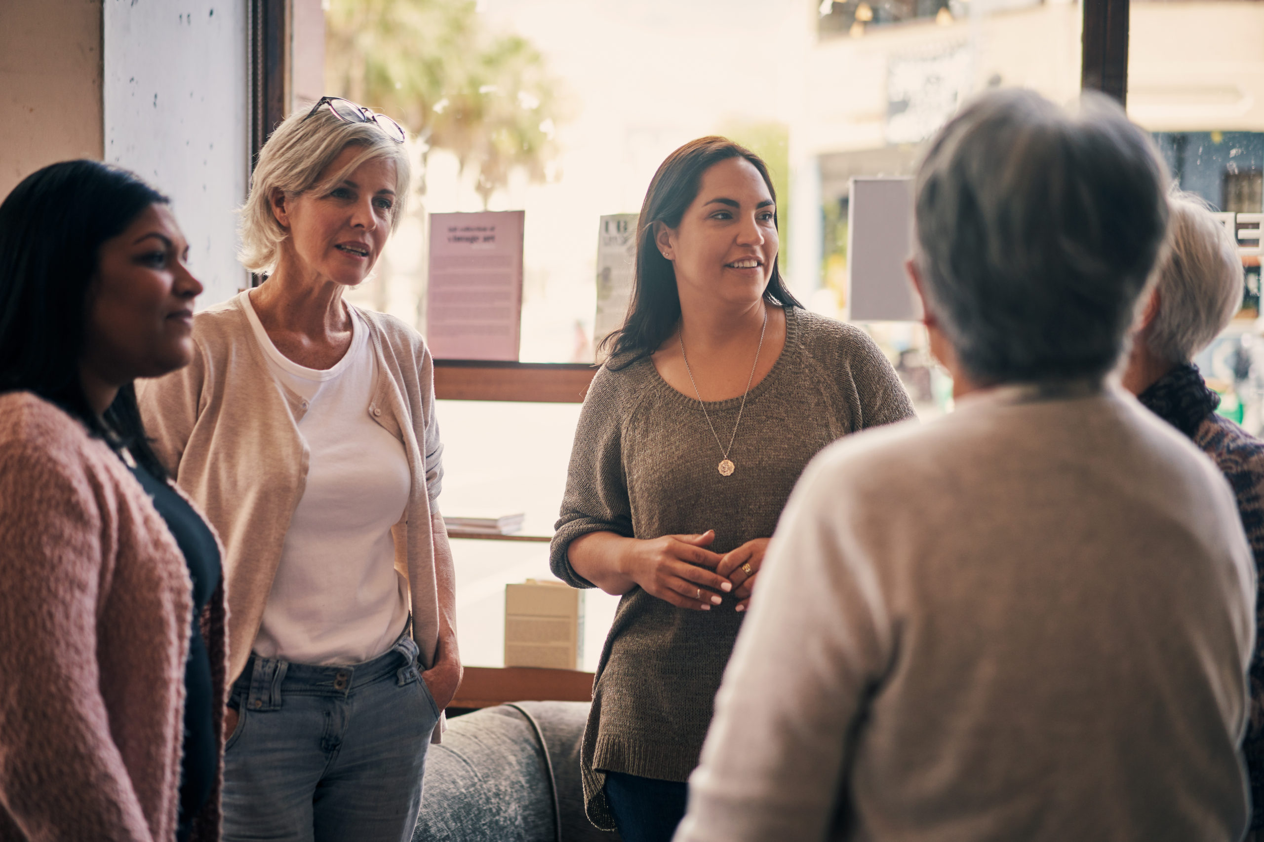 Photo of a diverse group of women attending a book club meeting at a bookstore