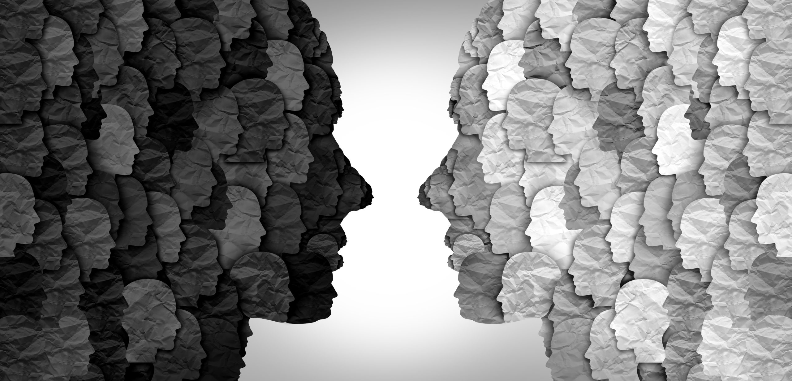 Illustration of silhouettes of two faces in profile facing one another with each silhouette comprised of smaller versions of the same larger face. One is comprised of shades of dark gray and black, the other of light gray and white.