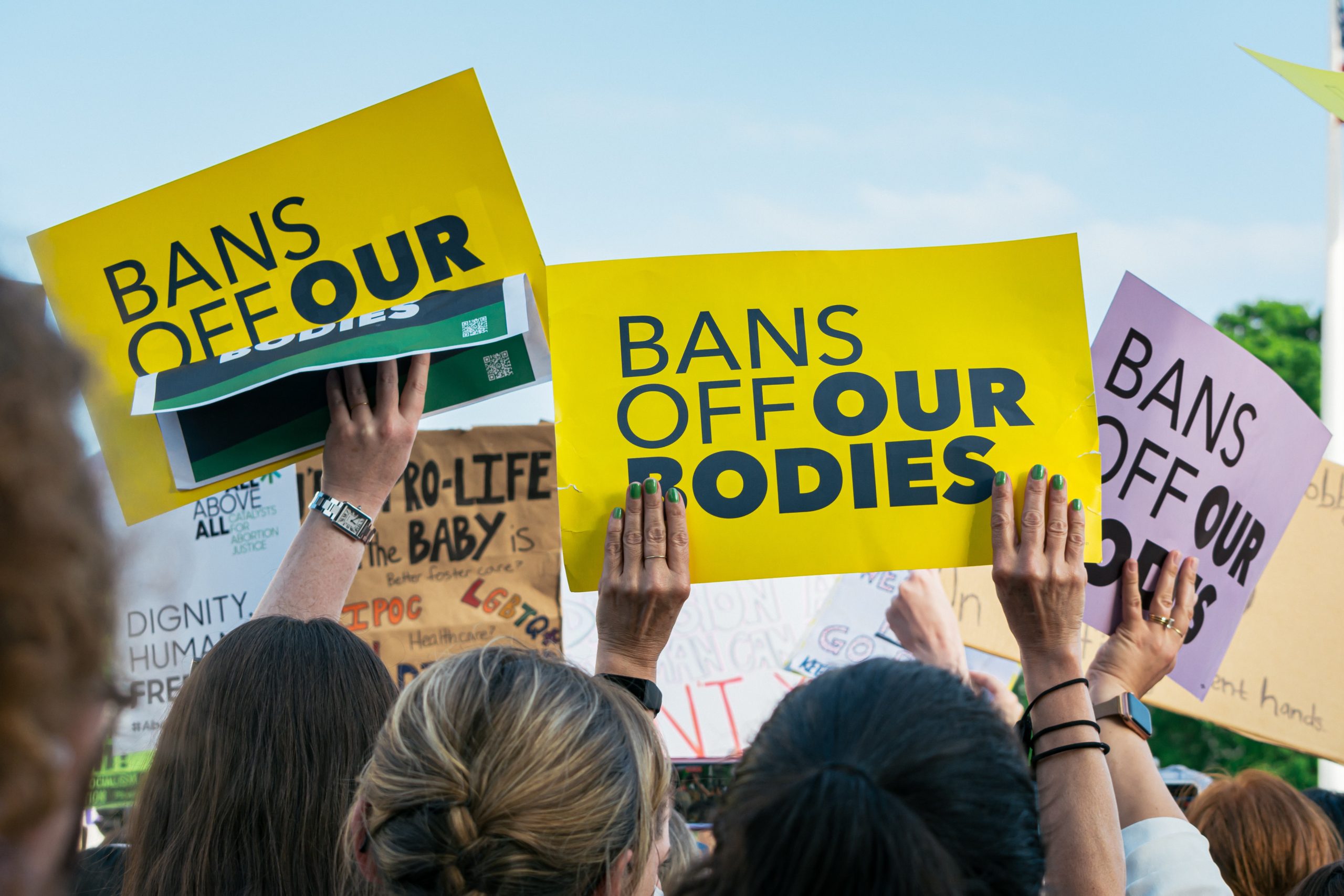Photo of protesters holding signs saying "Bans off our bodies"