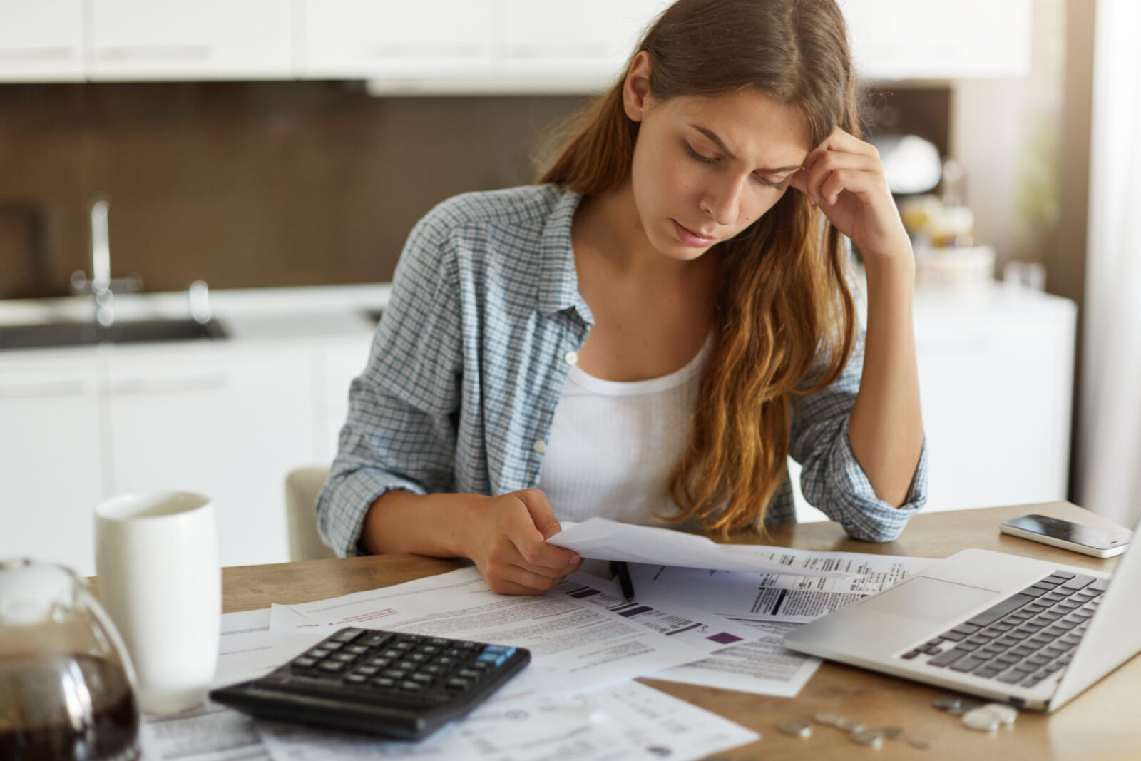 woman at table looking concerned looking at bills