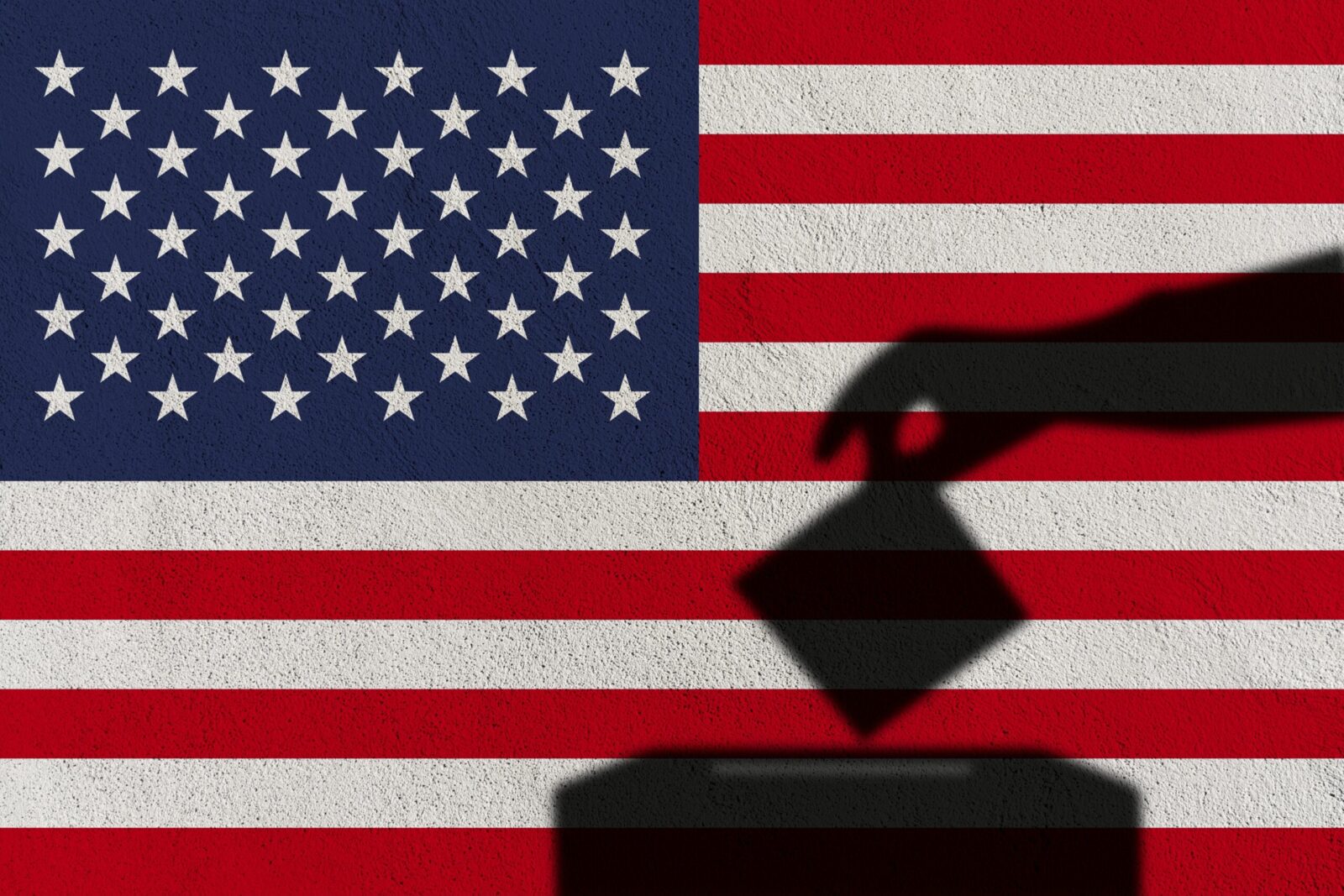 shadow of hand with ballot in front of american flag
