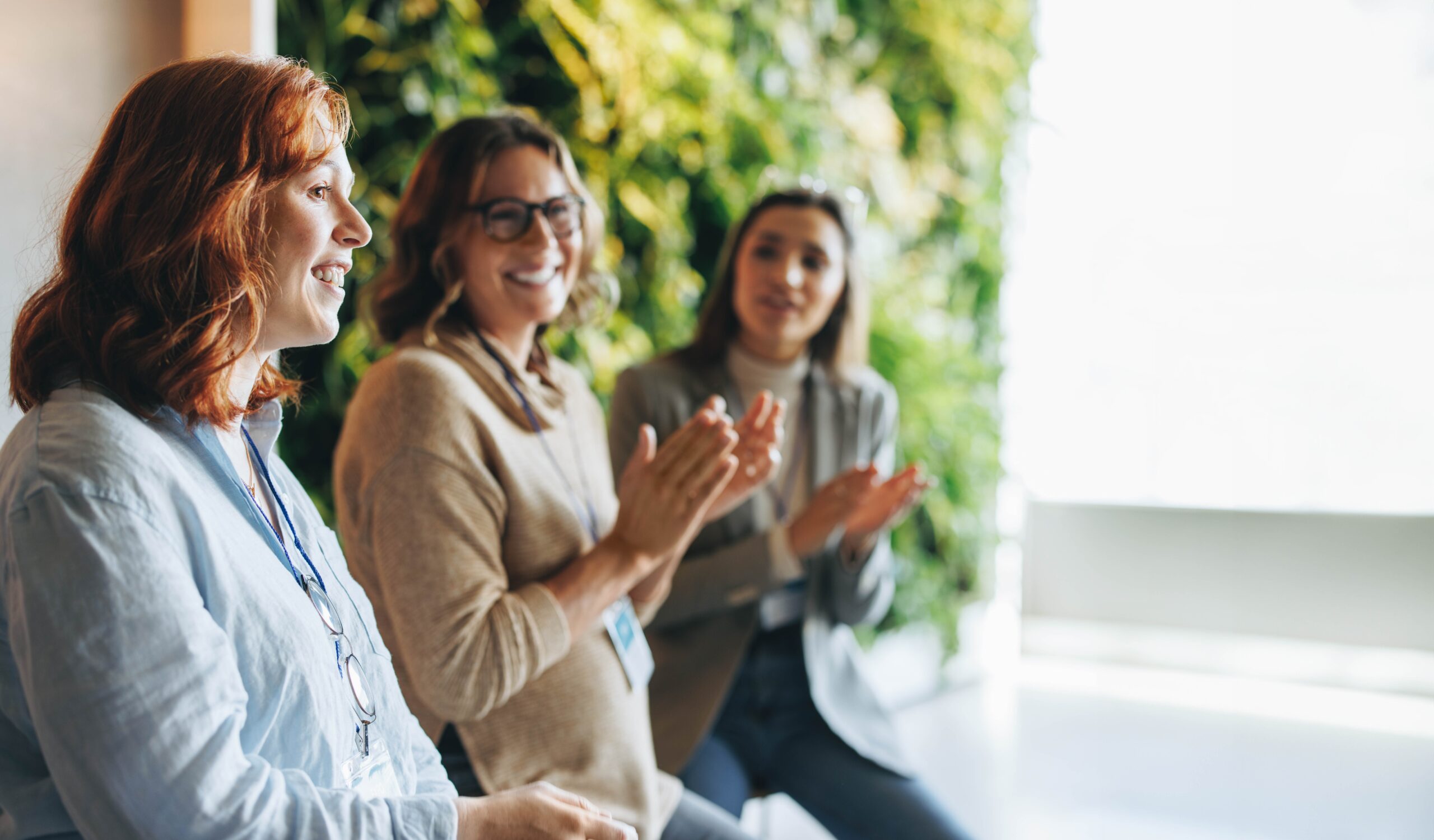 three women smiling and looking at each other